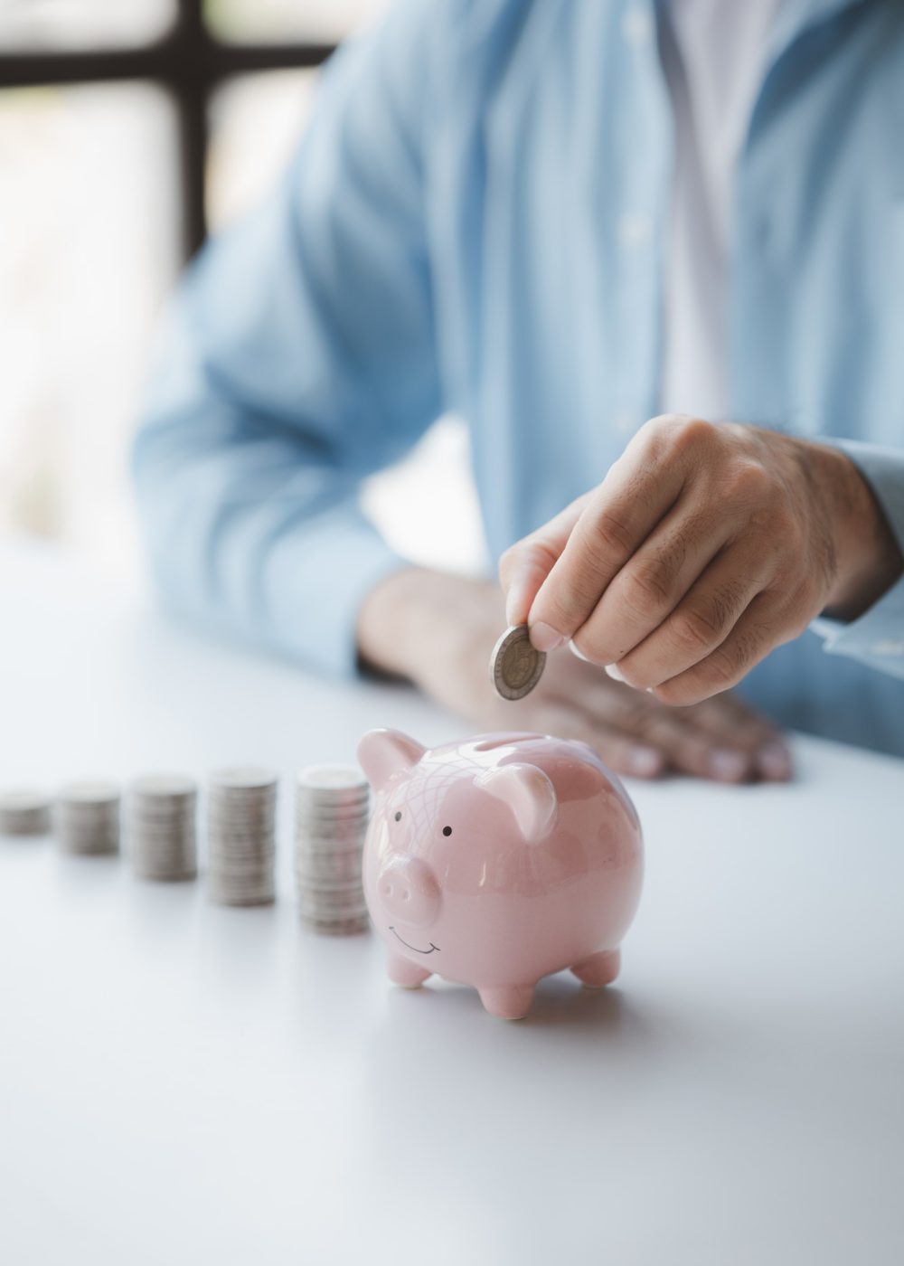 person-with-pile-of-coins-and-piggy-bank-money-saving-concept-for-future-use-and-financial-stabilit